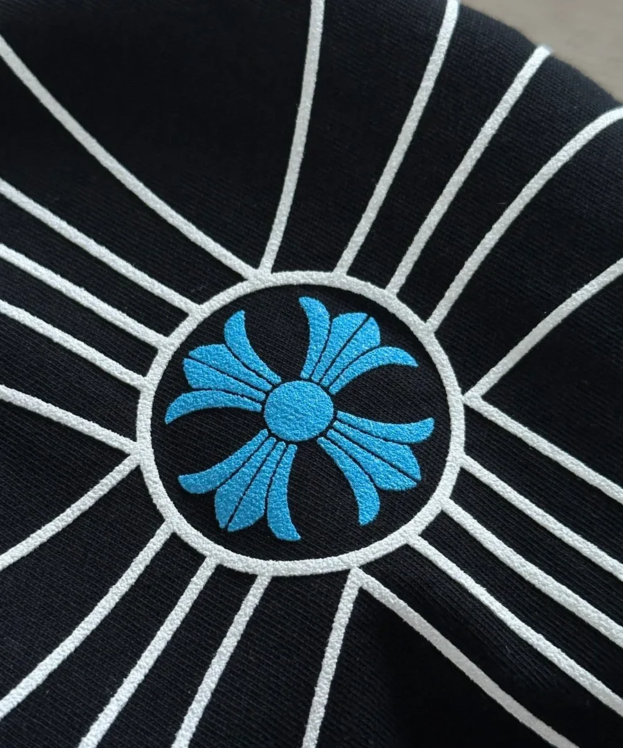 Деталь принта с голубым крестом на черном лонгсливе Chrome Hearts
