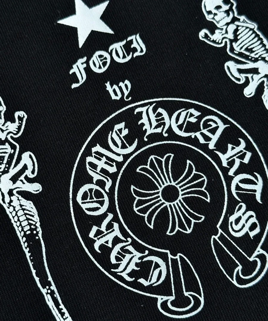 Крупный план принта Foti by Chrome Hearts на черной футболке