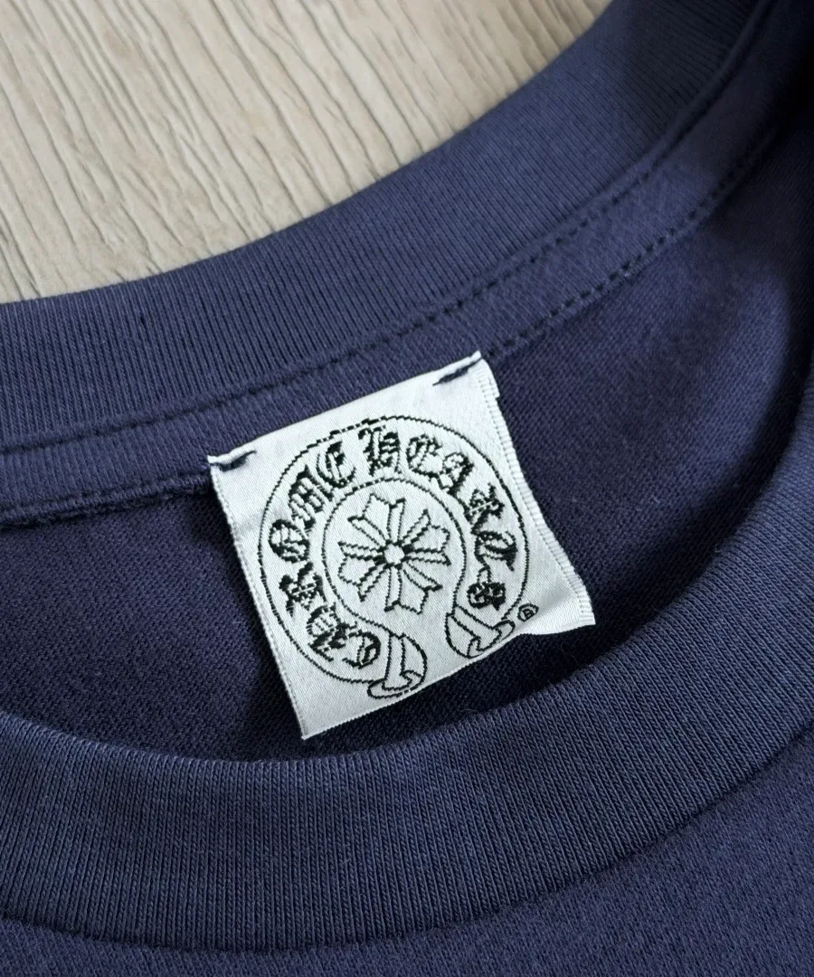 Круглый вырез горловины и фирменная бирка Chrome Hearts