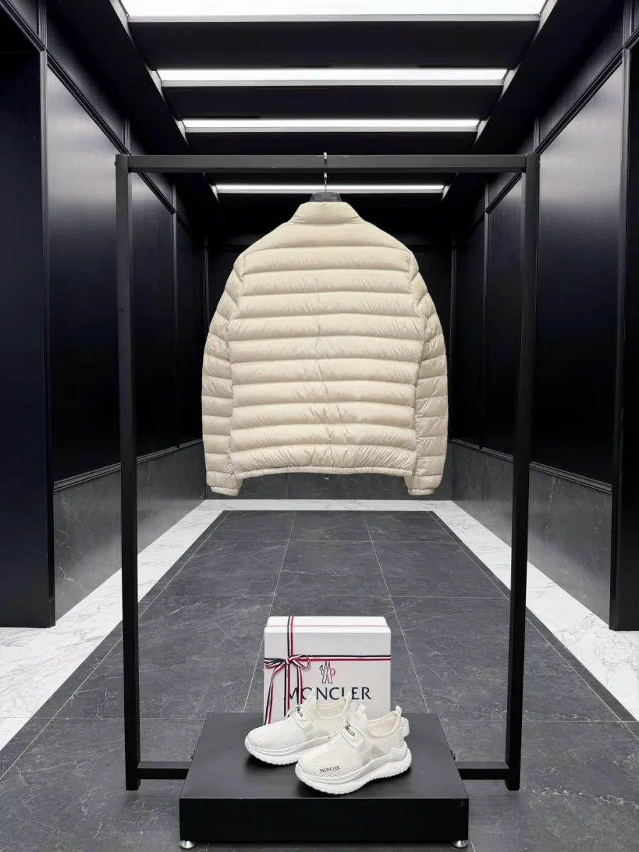 Бежевый стеганый пуховик Moncler Lans, вид сзади на стойке в шоуруме
