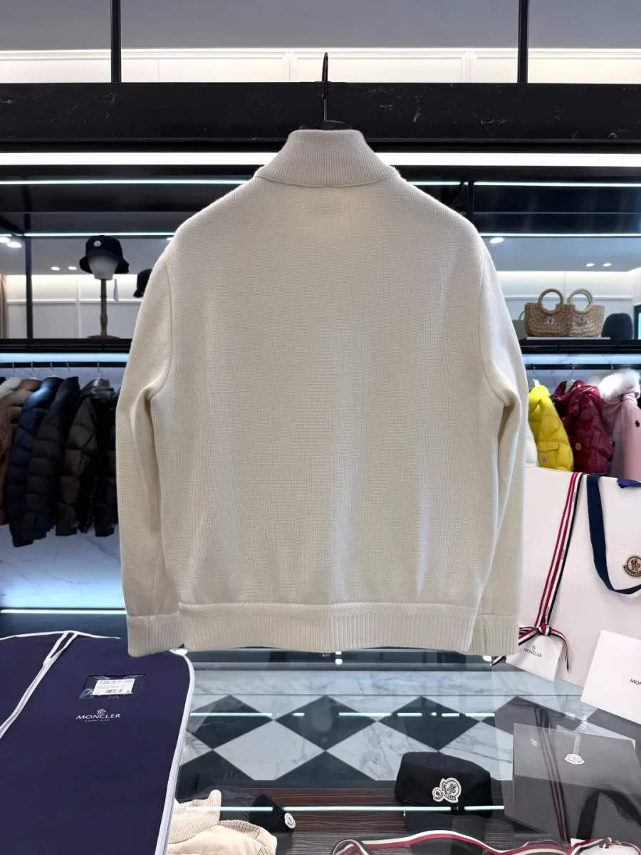 Вид сзади белого шерстяного кардигана Moncler на вешалке в шоуруме