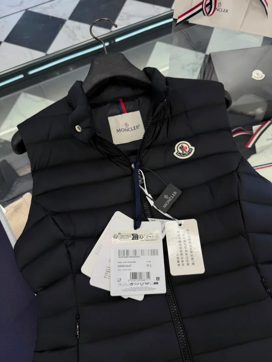 Верхняя часть чёрного пухового жилета Moncler с бирками и логотипом