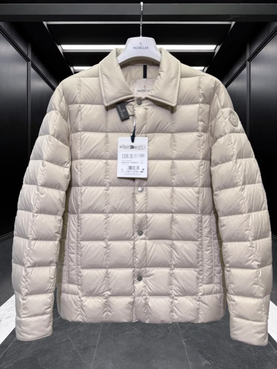 Стеганый бежевый пуховик Moncler рубашечного кроя с отложным воротником на вешалке