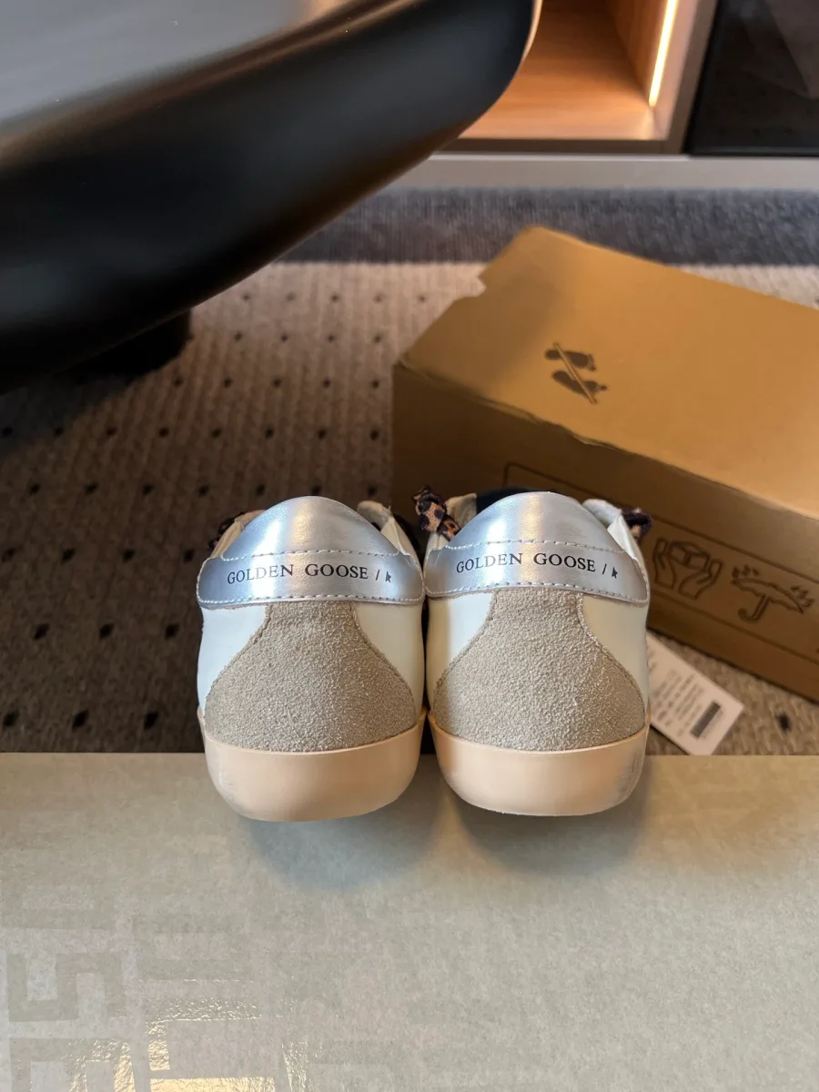 Вид сзади на пятки кед с серебристыми вставками и надписью Golden Goose