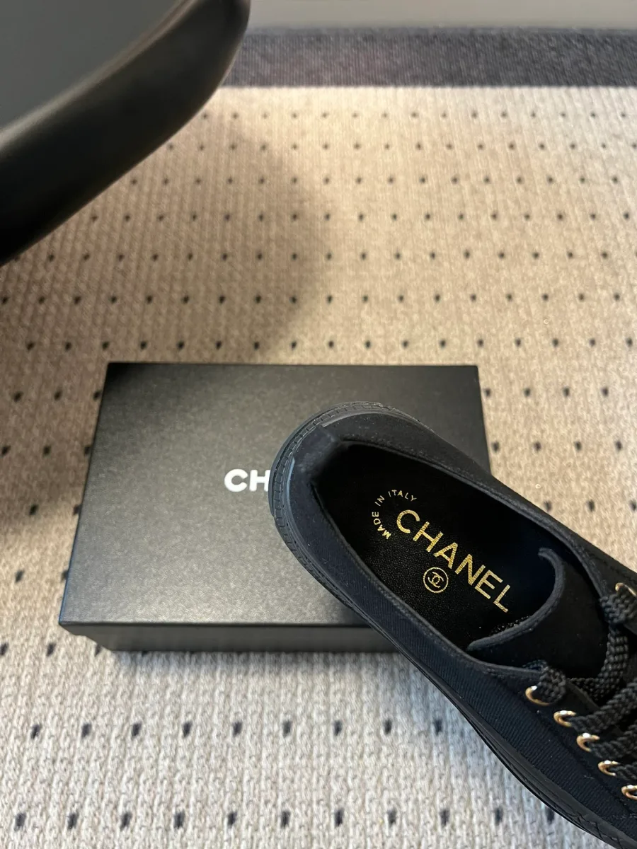 Крупный план кожаной стельки кеда Chanel с золотистым логотипом