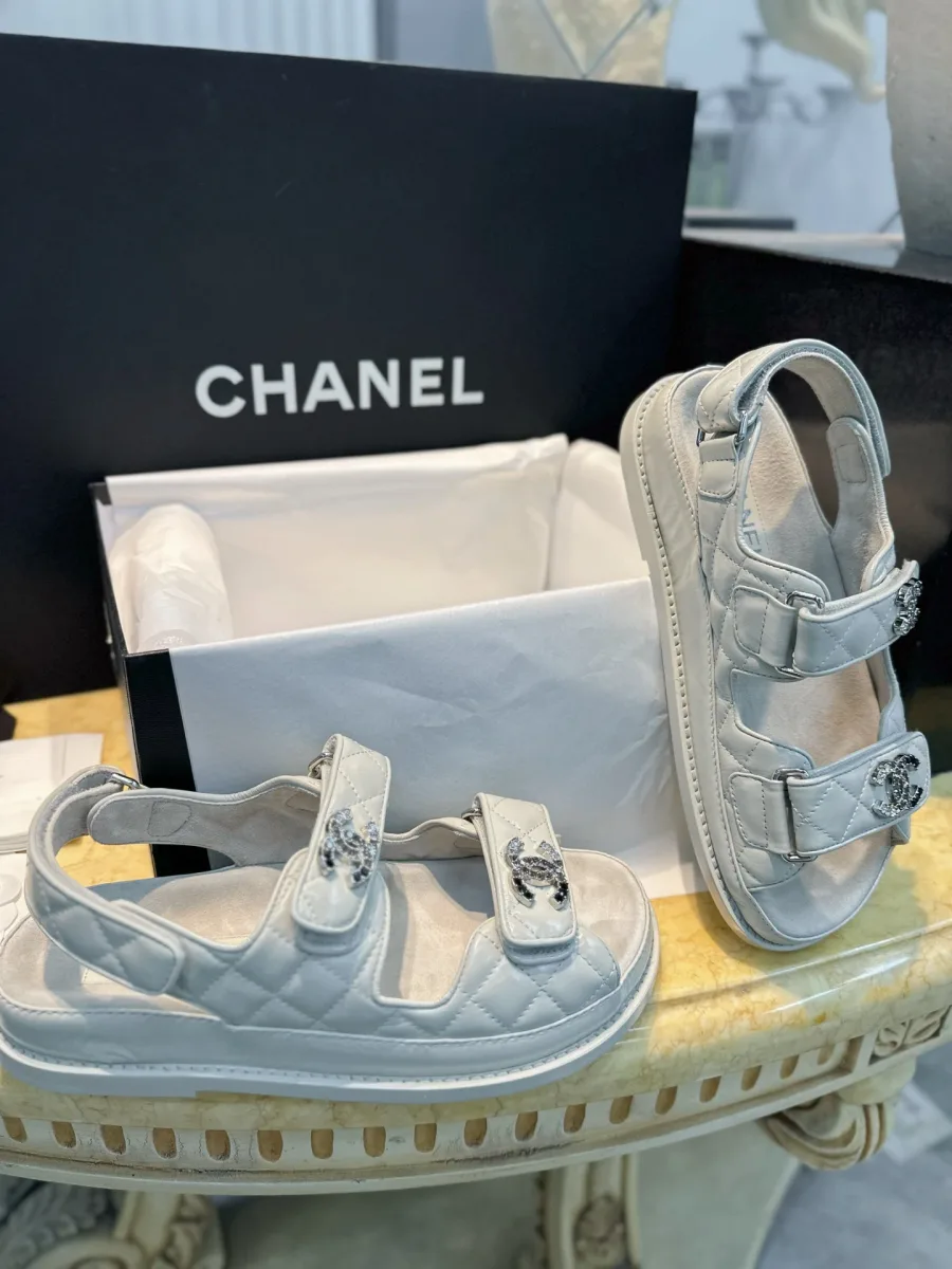 Белые сандалии Chanel возле коробки, вид сбоку
