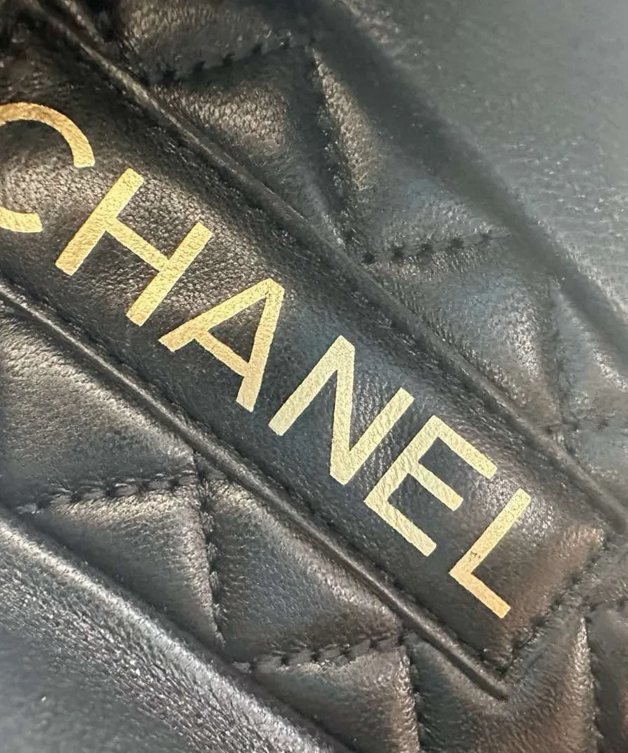 Крупный план стёганой стельки с золотистым логотипом Chanel