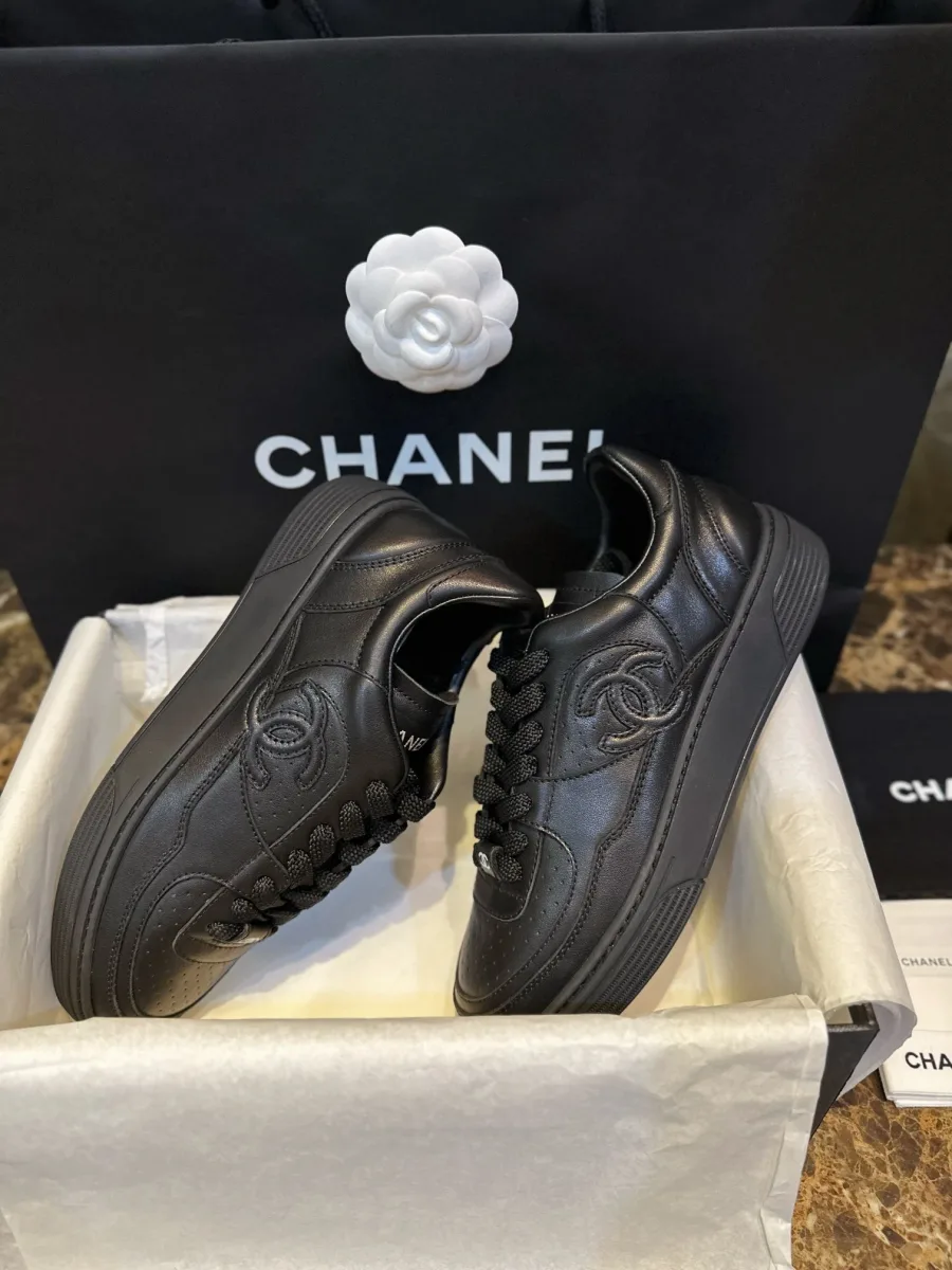 Пара чёрных кед Chanel в коробке, вид сбоку