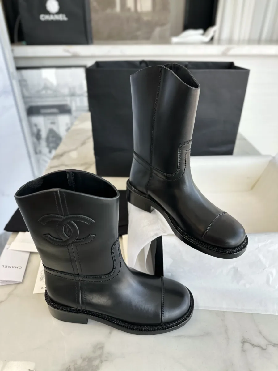 Чёрные сапоги Chanel на светлом фоне, вид сбоку и спереди
