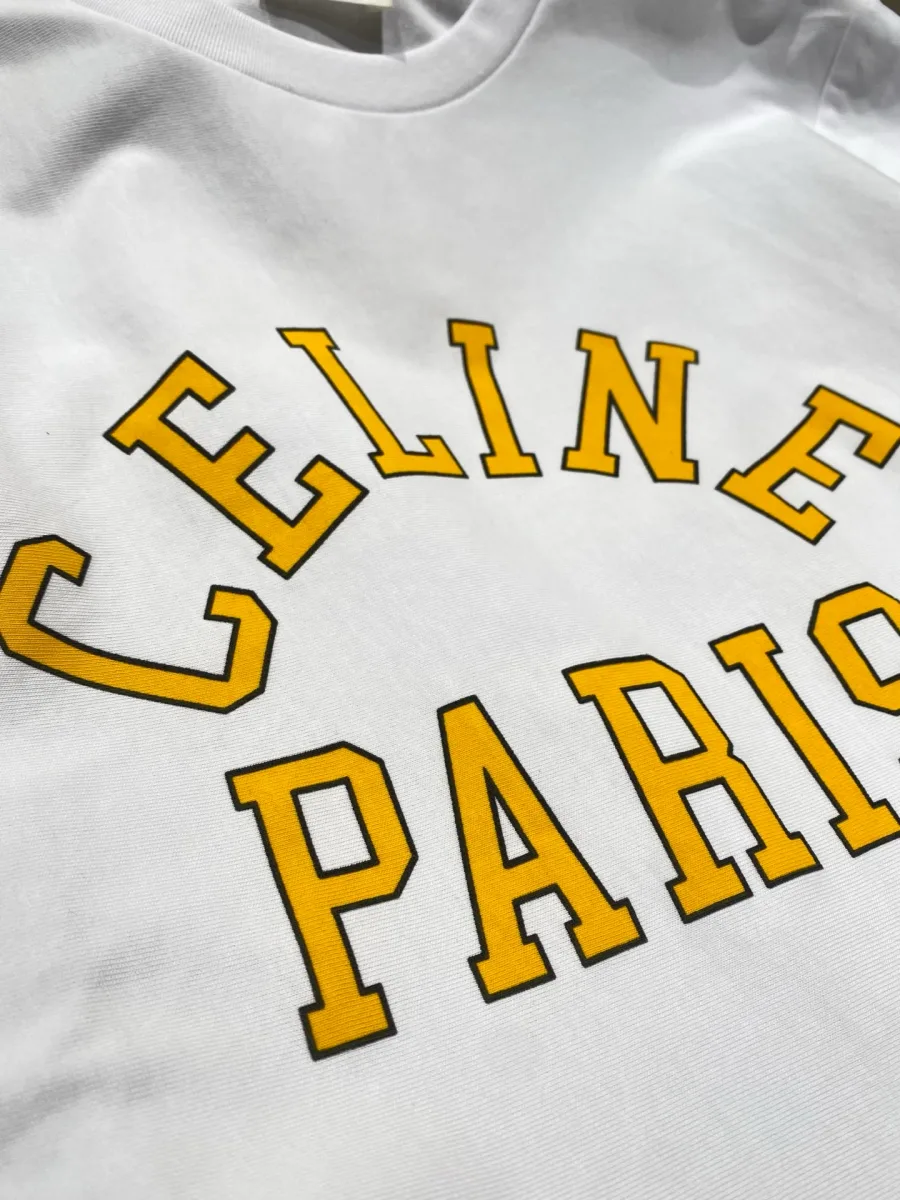 Контрастный жёлтый арочный принт Celine Paris на белой хлопковой ткани крупным планом