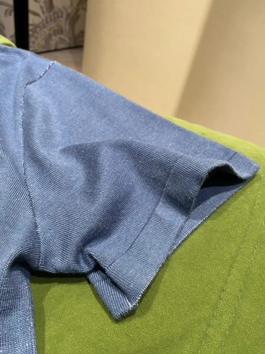 Рукав голубой трикотажной футболки с эластичной манжетой крупным планом