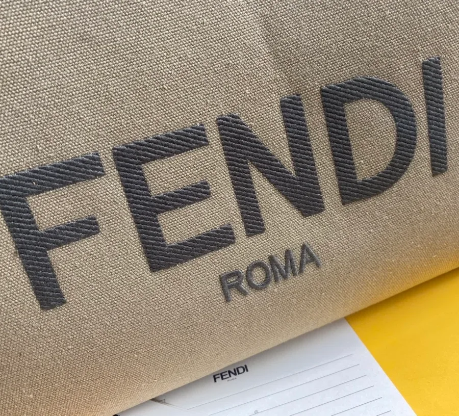Крупный план вышитого логотипа Fendi Roma на зелёном канвасе