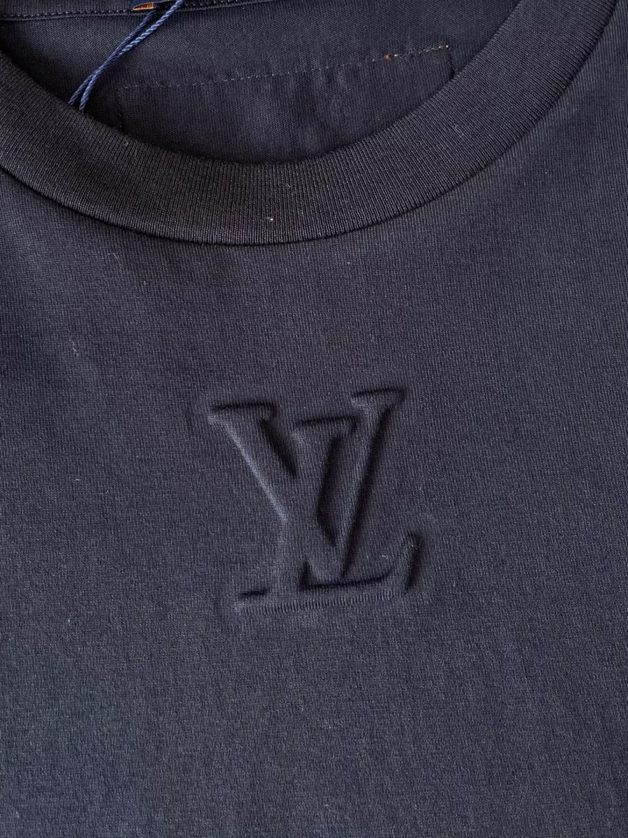 Крупный план рельефного тиснения монограммы LV в тон ткани