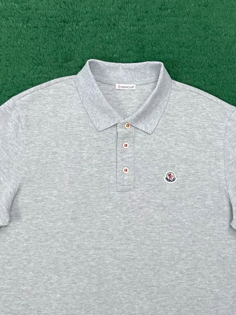 Верхняя часть серого поло с отложным воротником и планкой на пуговицах