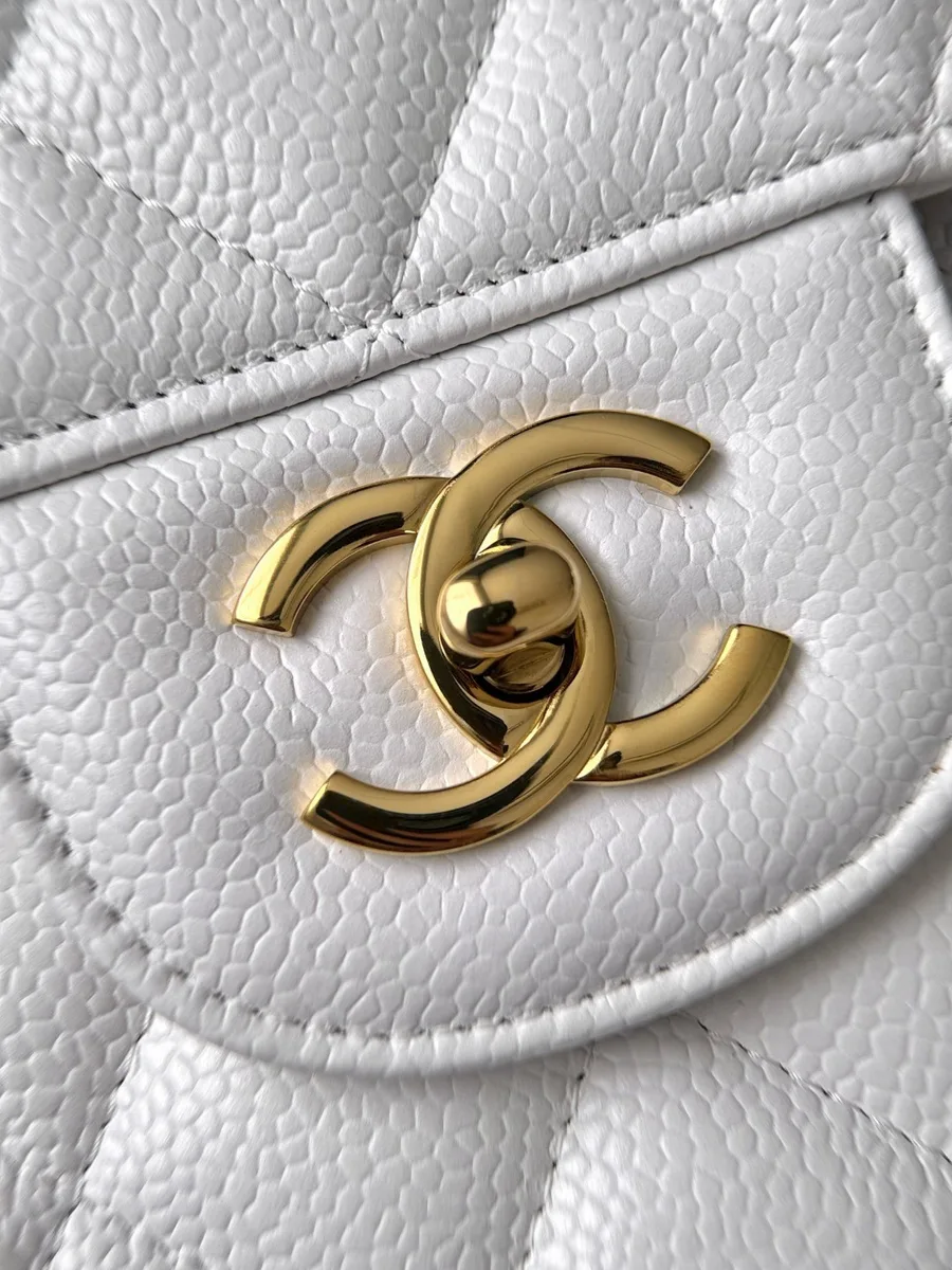 Золотистый поворотный замок CC на белой зернистой коже сумки Chanel