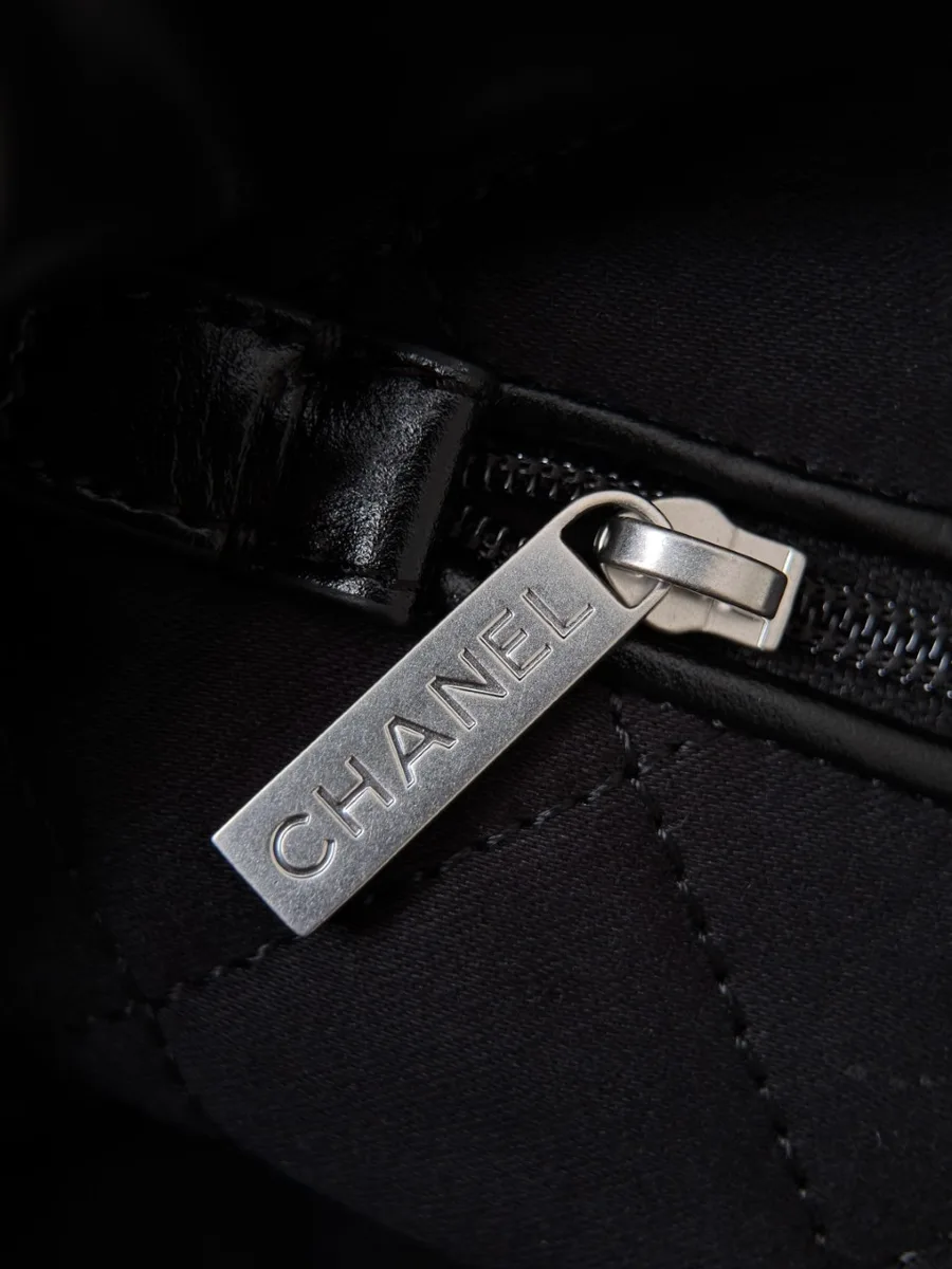 Крупный план металлического пуллера молнии с надписью Chanel