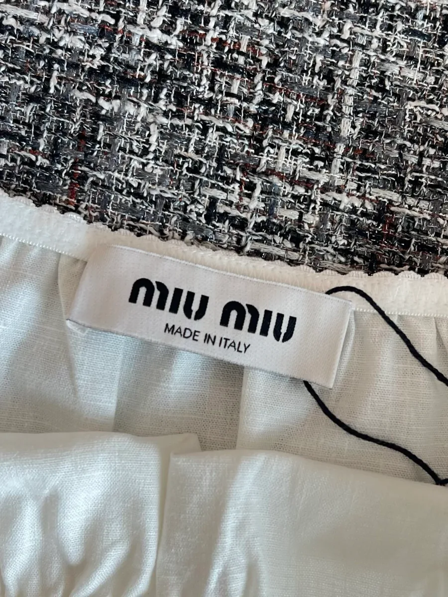 Тканевый ярлык с логотипом Miu Miu на внутренней стороне юбки