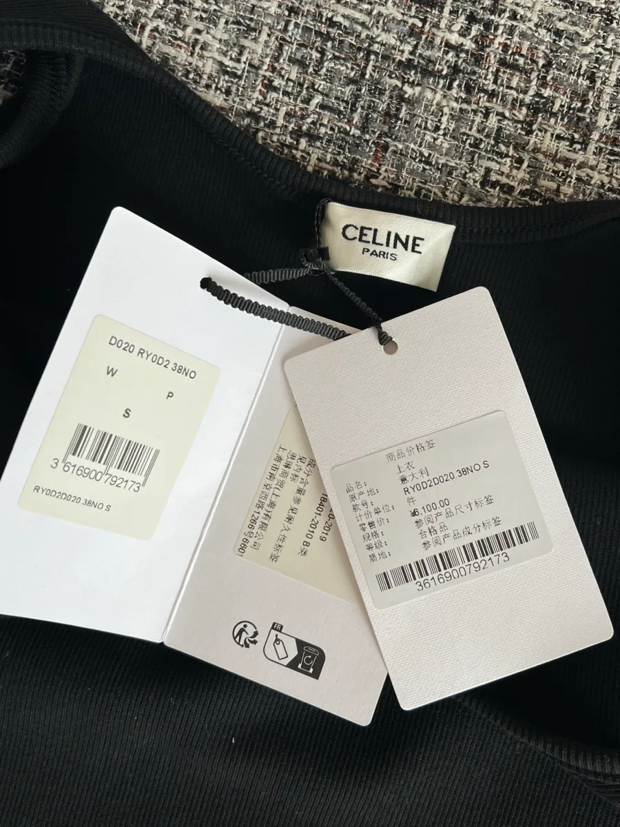 Фирменные бумажные ярлыки Celine на фоне чёрной майки