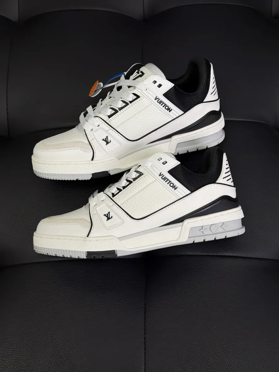 Пара кроссовок LV Trainer из белой и чёрной кожи, вид сбоку