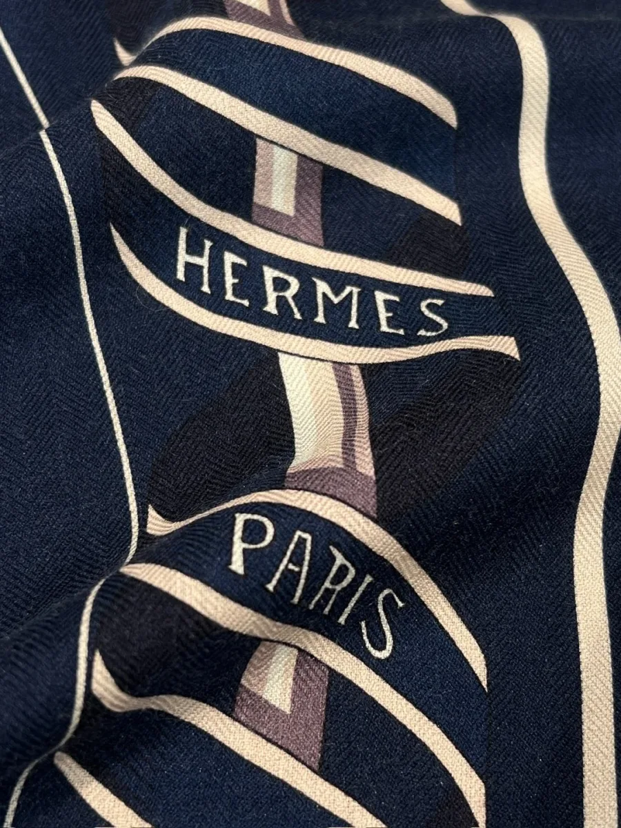 Крупный план ленты с надписью Hermes Paris и фактуры ткани полотна
