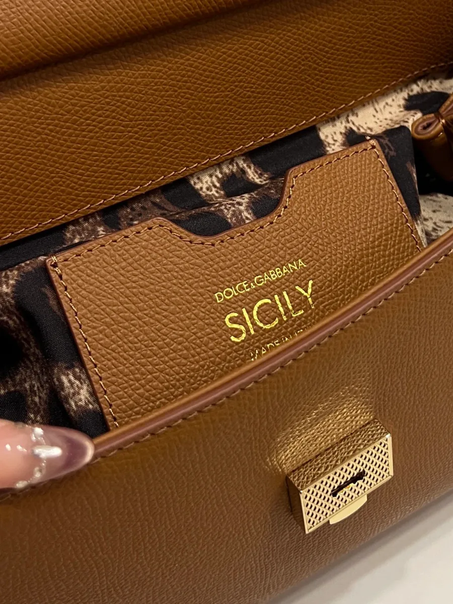 Крупный план внутреннего кармана сумки Sicily с золотистым тиснением и леопардовой подкладкой