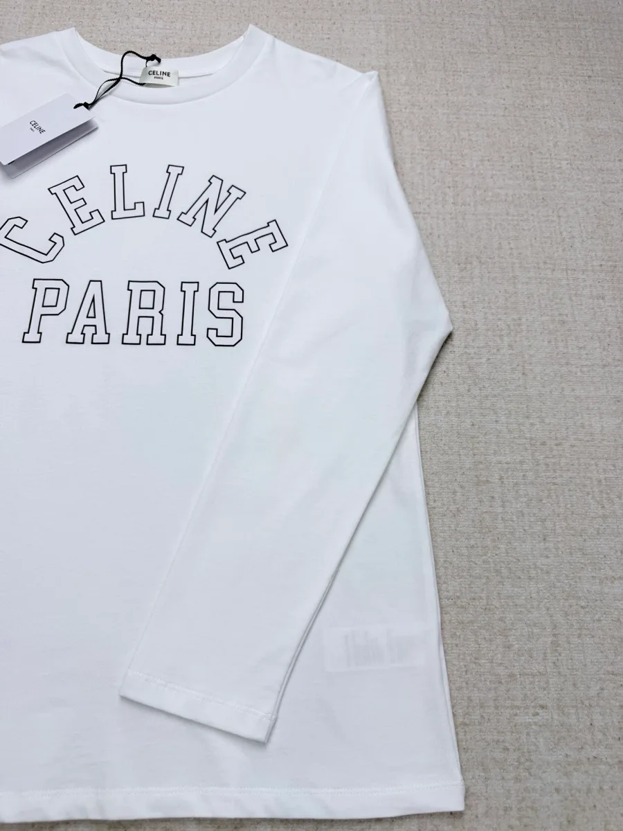 Белый лонгслив с надписью Celine Paris, вид сбоку с биркой