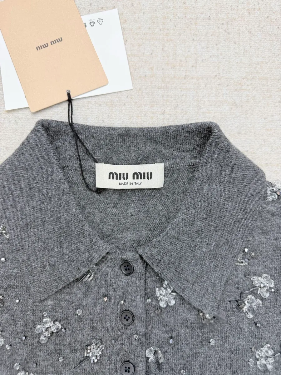 Отложной воротник и бирка серого вязаного поло крупным планом