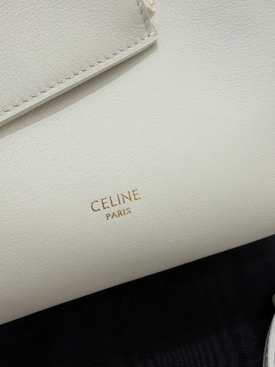 Золотистое тиснение логотипа бренда Celine Paris на белой коже