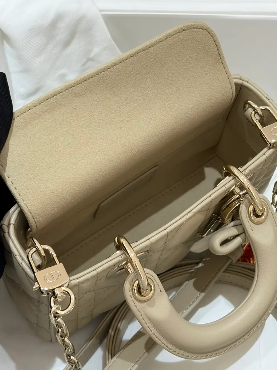 Внутреннее отделение открытой бежевой сумки Dior с клапаном