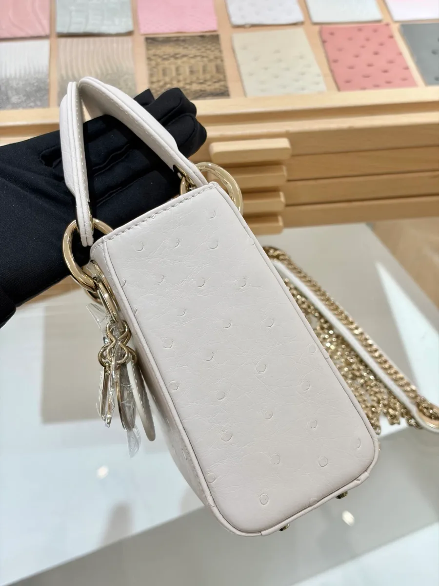 Белая сумка Lady Dior 17 из кожи страуса, вид сбоку с подвеской
