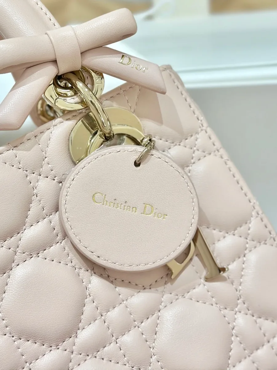 Крупный план кожаного ярлыка с тиснением Christian Dior на розовой сумке
