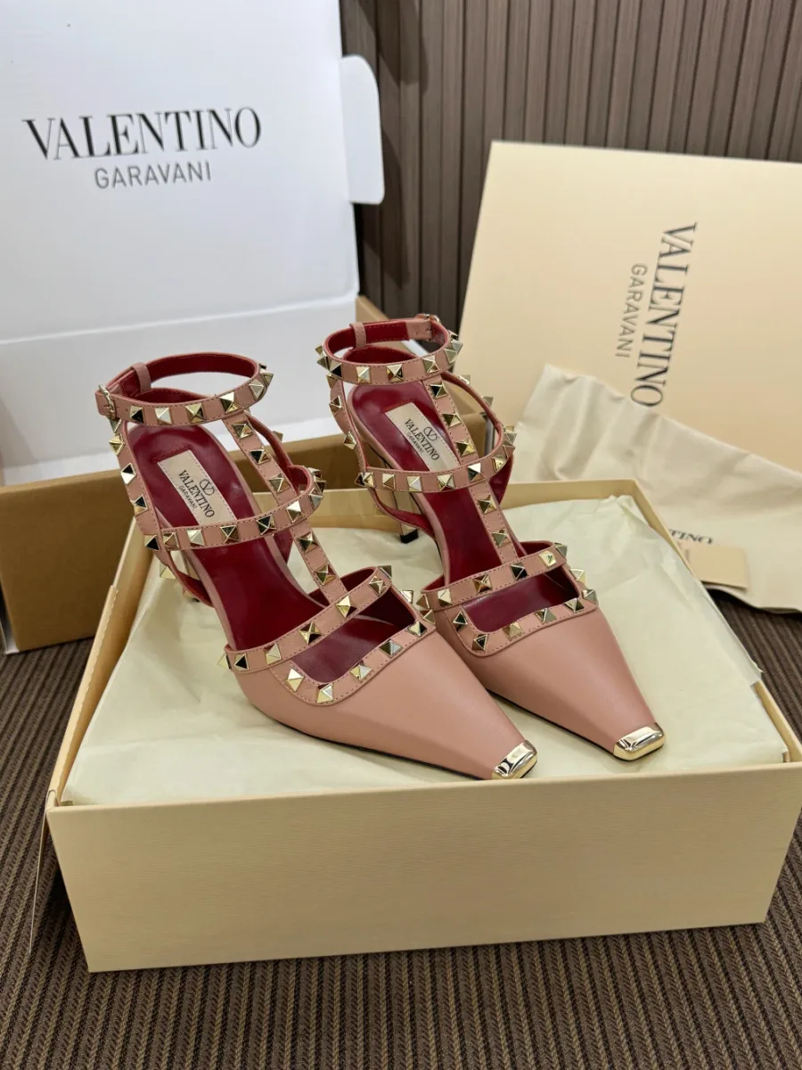 Пара босоножек Valentino с ремешками и шипами в открытой коробке, вид сверху-спереди