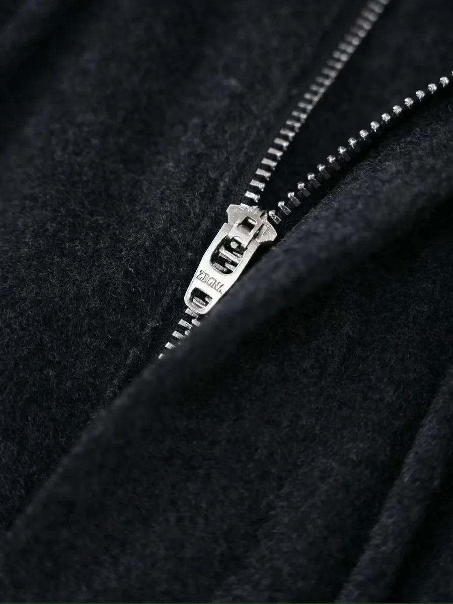 Графитовые брюки Zegna крупным планом с металлической застёжкой-молнией и фактурной тканью