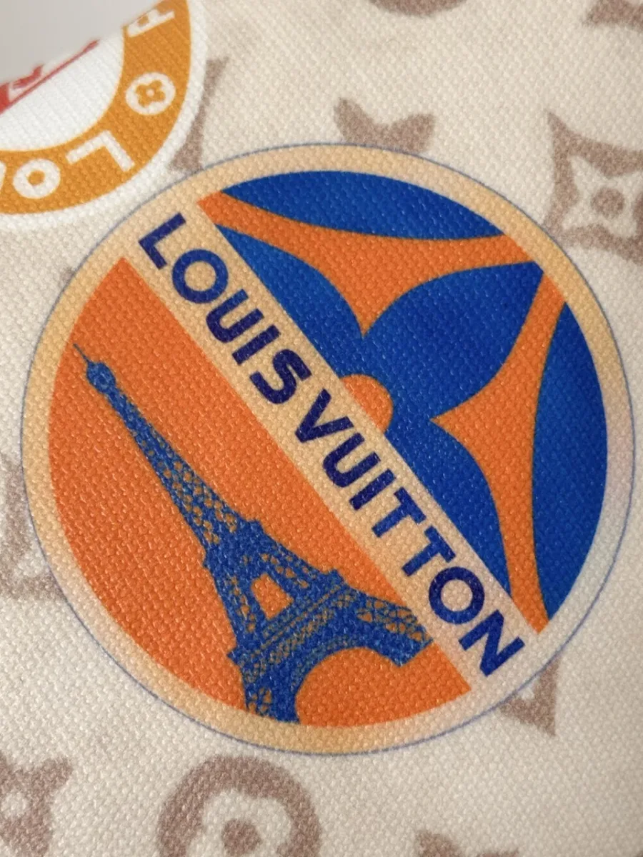 Крупный план круглого принта с изображением Эйфелевой башни и надписью Louis Vuitton