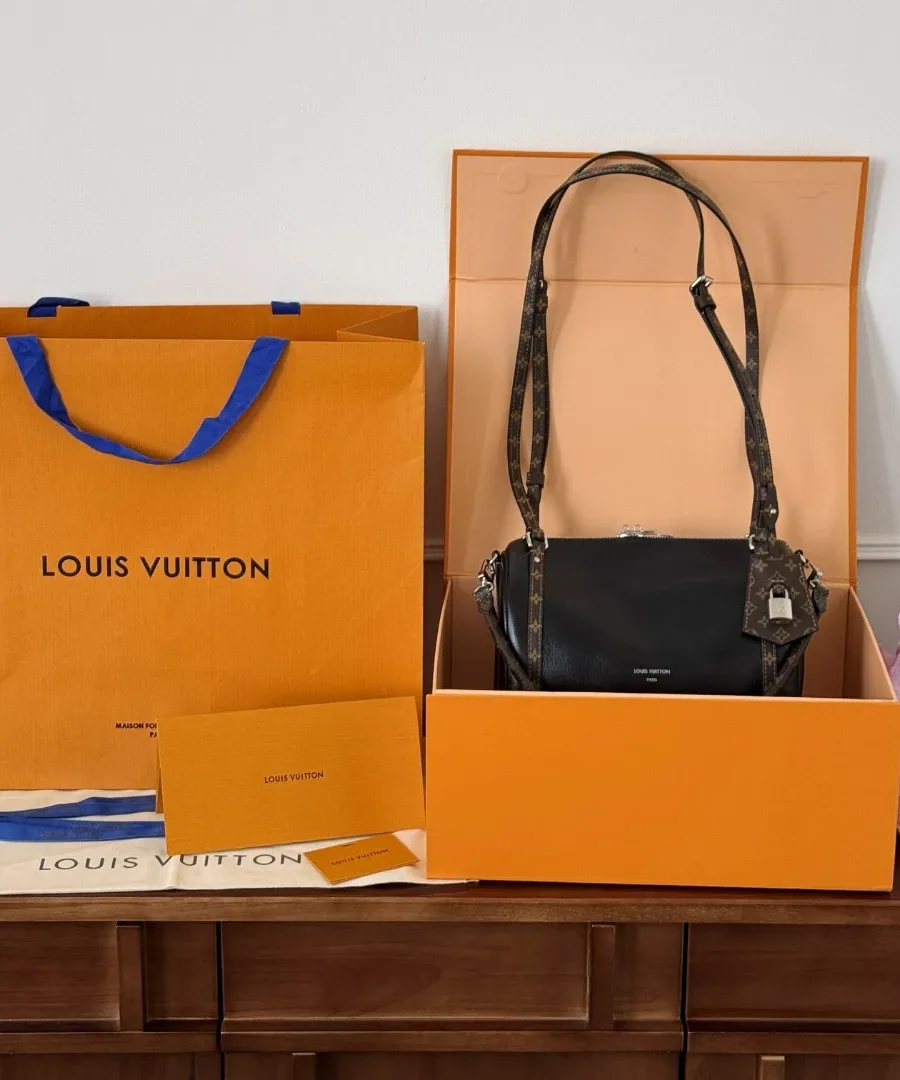 Сумка Louis Vuitton Express рядом с фирменной коробкой и пакетом