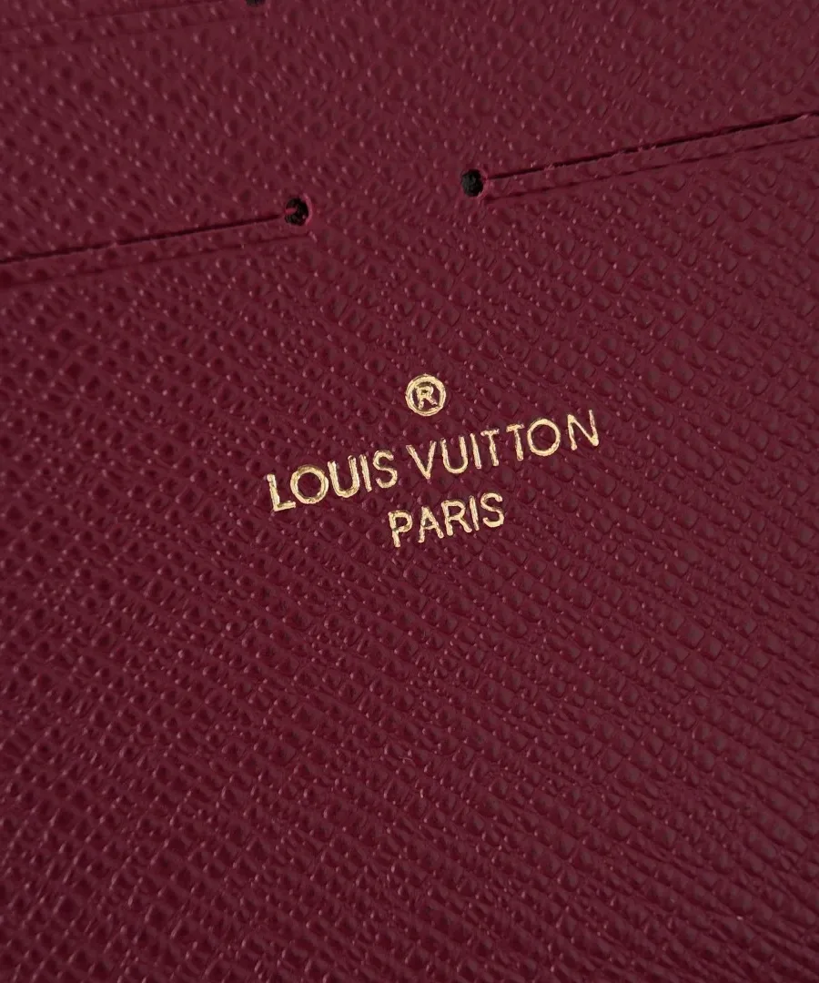 Крупный план золотистого тиснения Louis Vuitton Paris на подкладке цвета фуксии