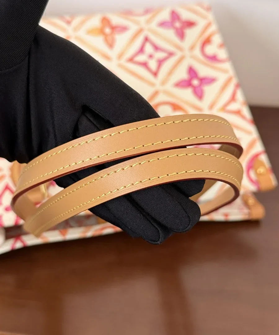Кожаные плечевые ремни сумки Louis Vuitton OnTheGo MM в руке