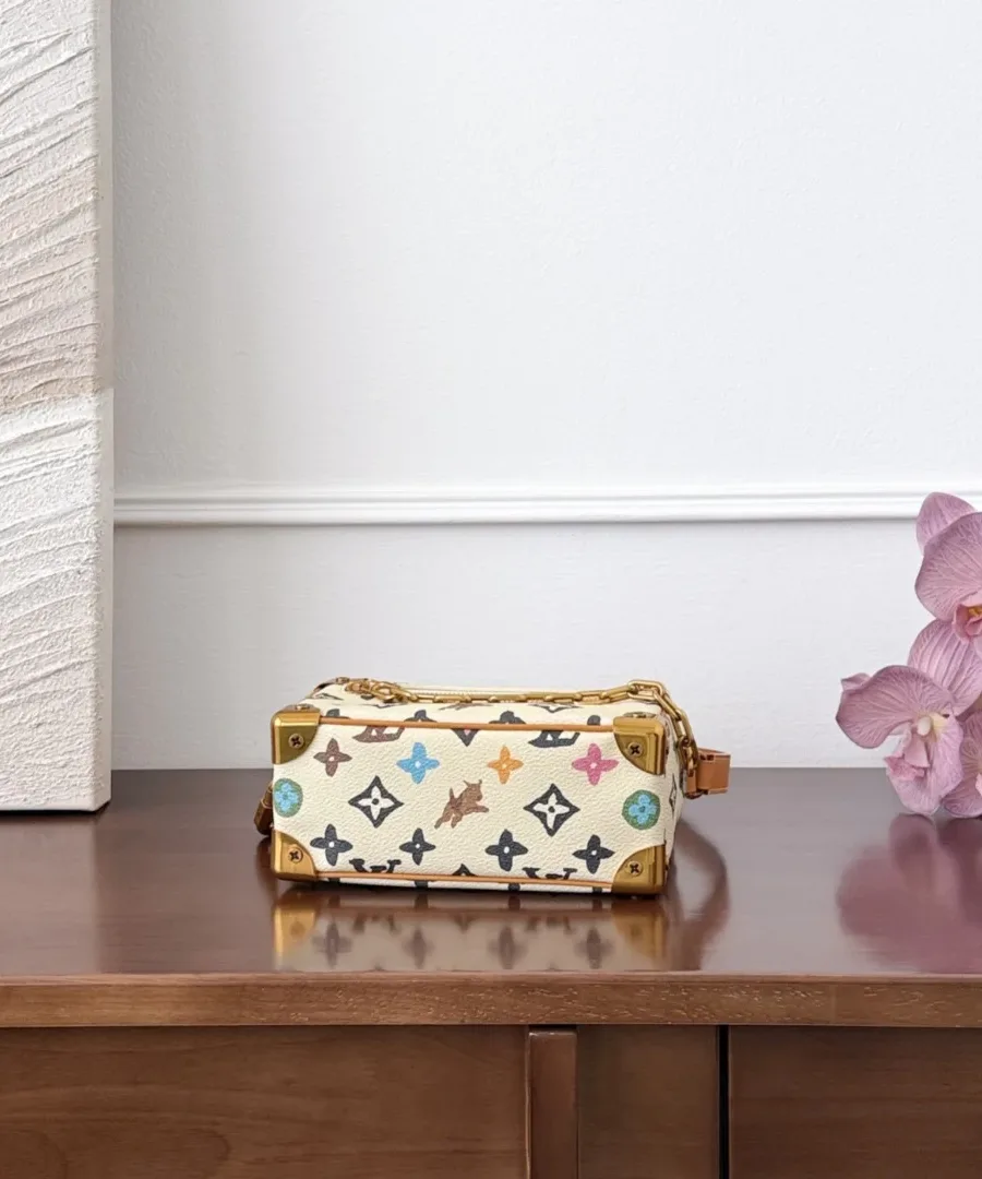 Сумка Louis Vuitton Mini Soft Trunk, вид снизу на деревянном столе