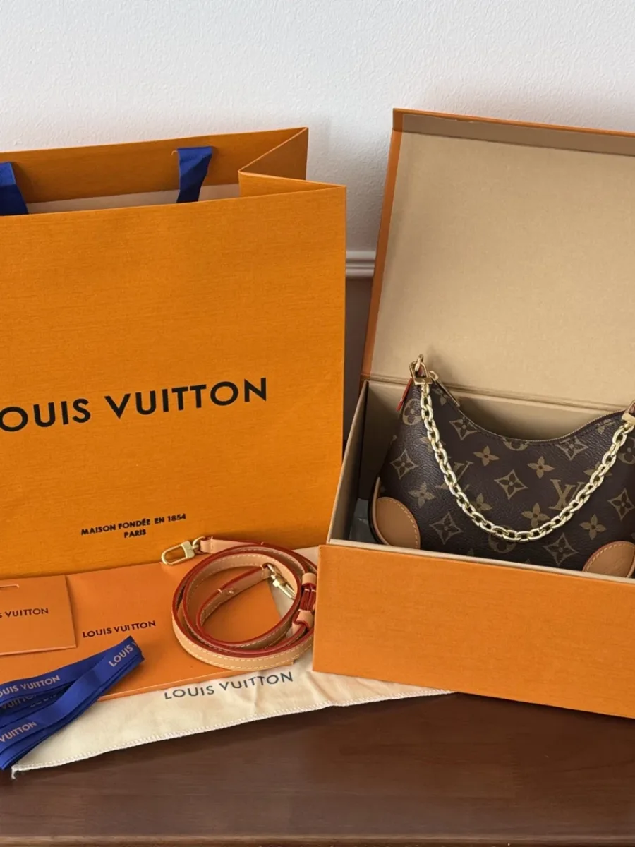 Сумка Louis Vuitton Croissant Mini в фирменной коробке рядом с пакетом и пыльником