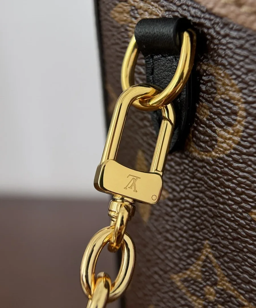 Крупный план карабина золотистой цепочки сумки Louis Vuitton