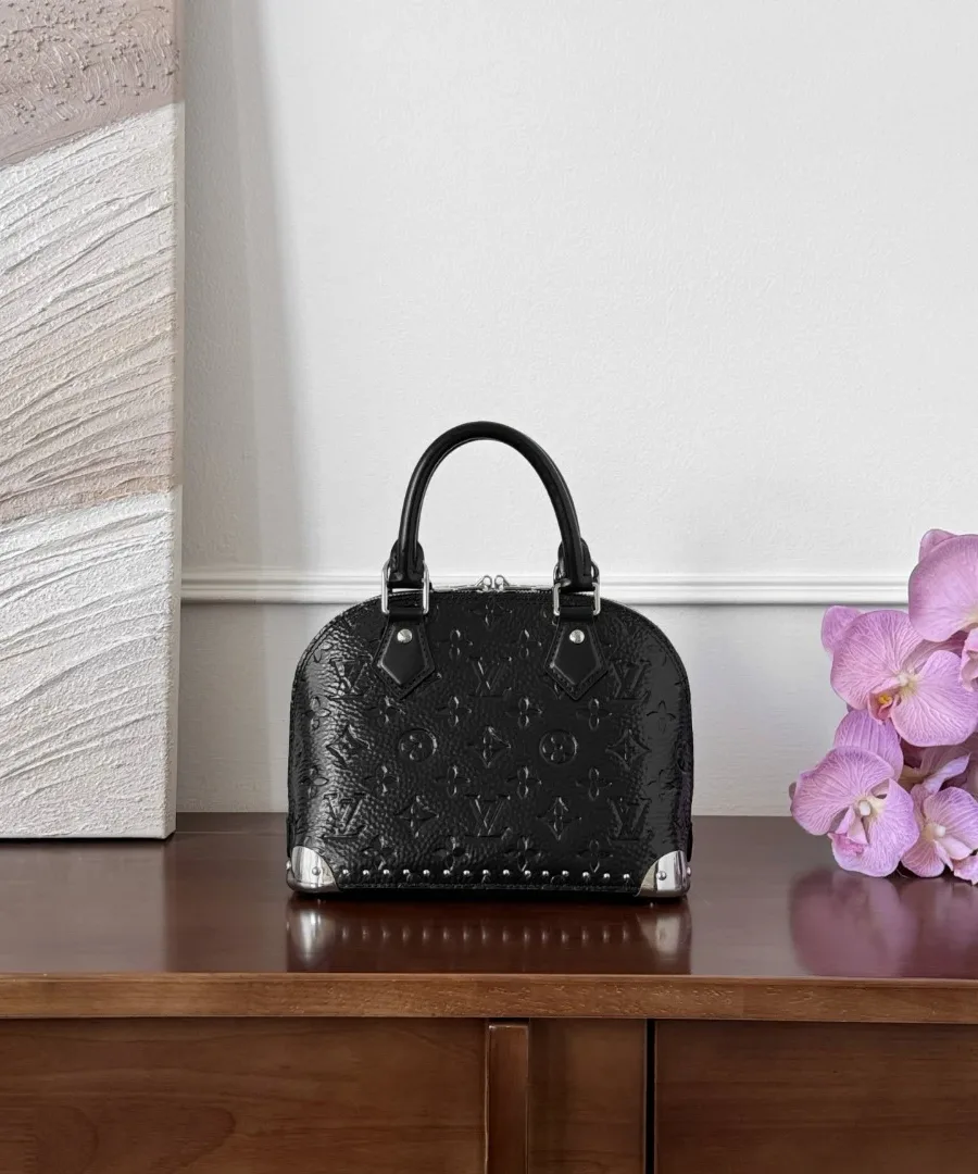 Чёрная лаковая сумка Louis Vuitton Alma BB Trunk на деревянном столе, вид спереди