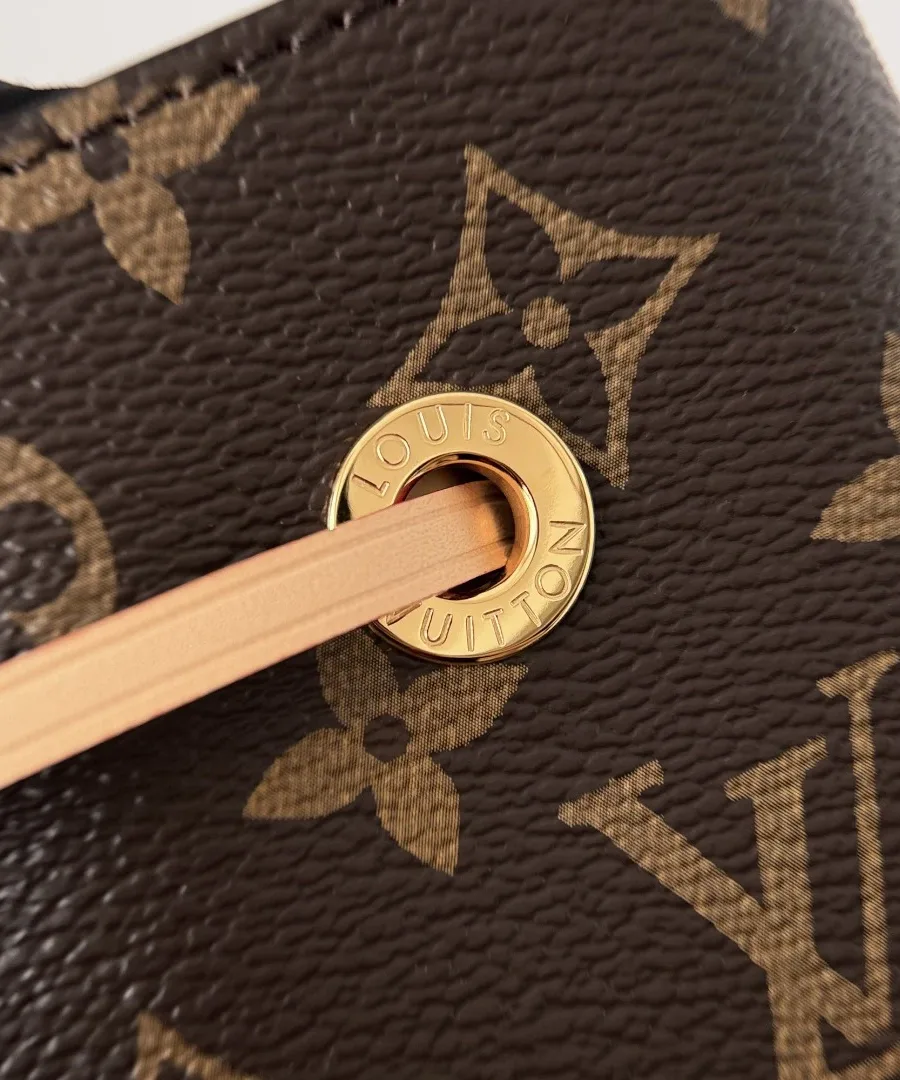 Золотистый люверс с гравировкой Louis Vuitton на канве Monogram