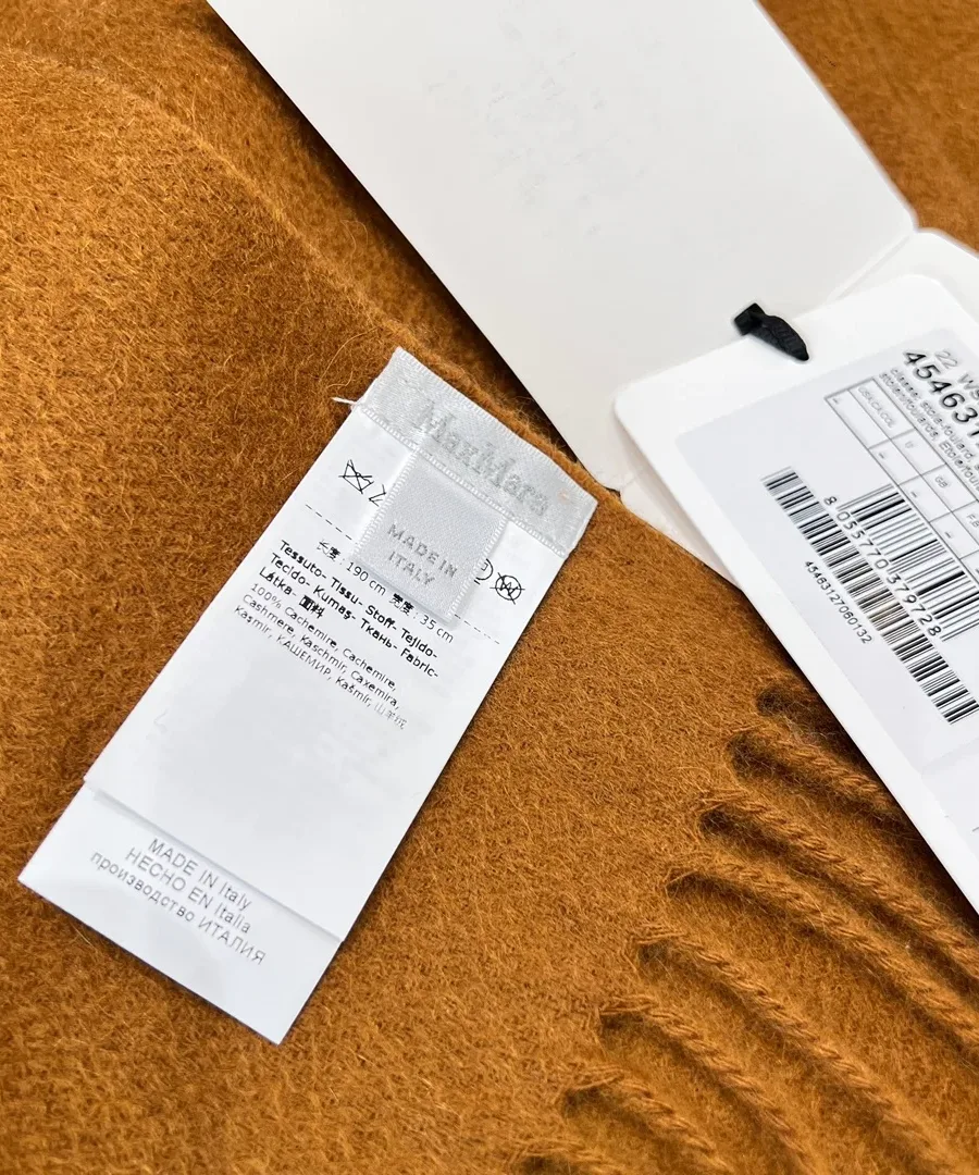 Вшивной ярлык бренда Max Mara с рекомендациями по уходу и бирка