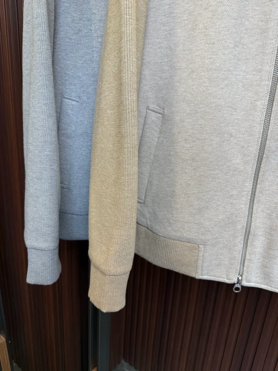 Нижняя часть бежевого пуховика, прорезной карман, трикотажный пояс и манжет рукава