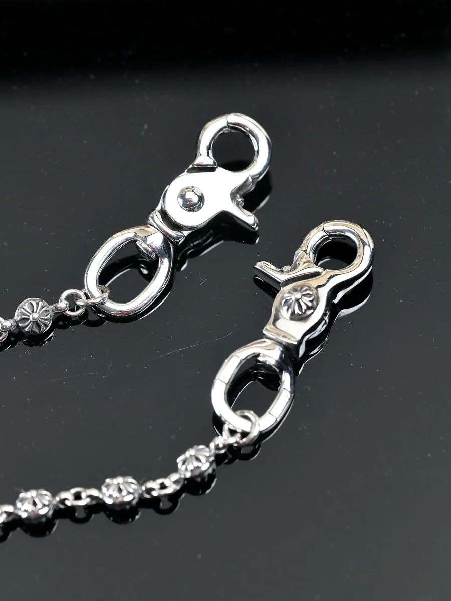 Крупный план поворотных карабинов цепи Chrome Hearts с гравировкой