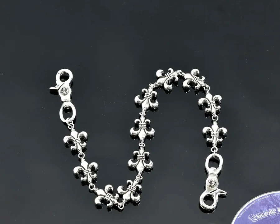 Серебряная цепь Chrome Hearts с лилиями изогнутой формы на темном фоне